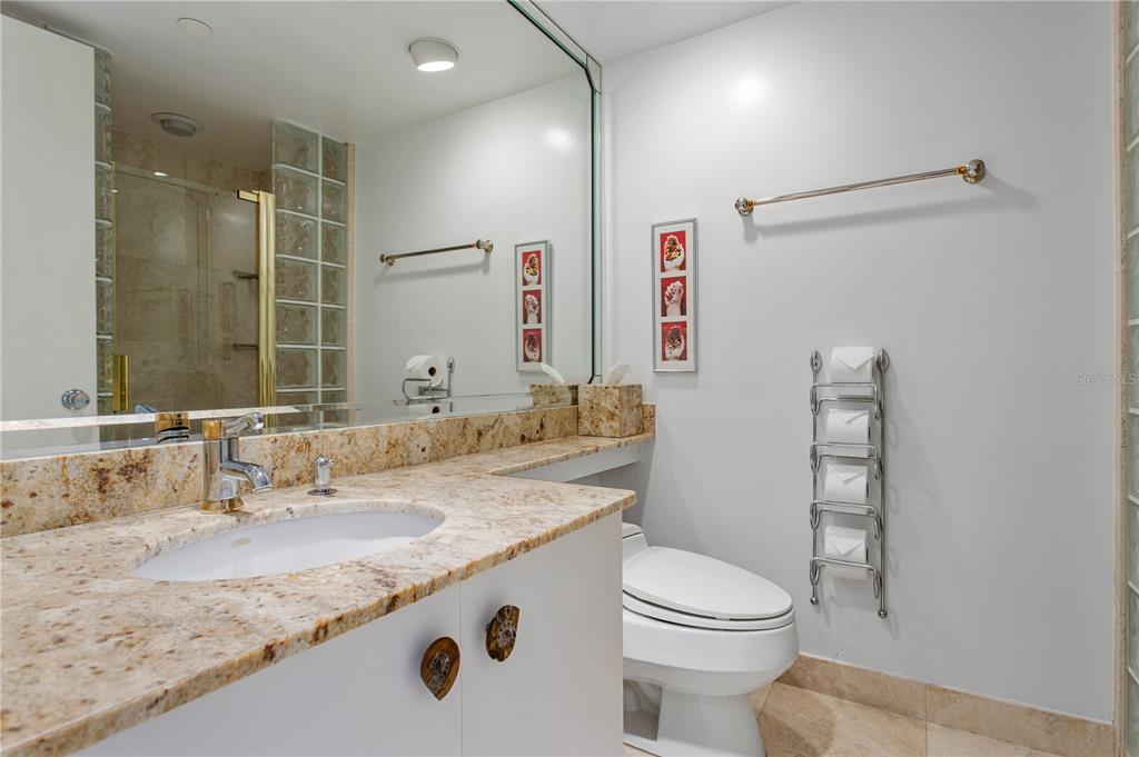 775 Longboat Club Road, Unit 808 Longboat Key, FL 34228 - Photo 26 of 41 a bathroom with a granite countertop sink toilet and shower