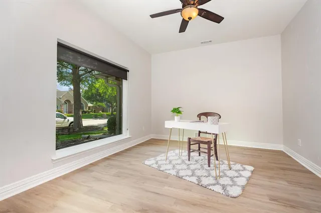 a work room with furniture and a window