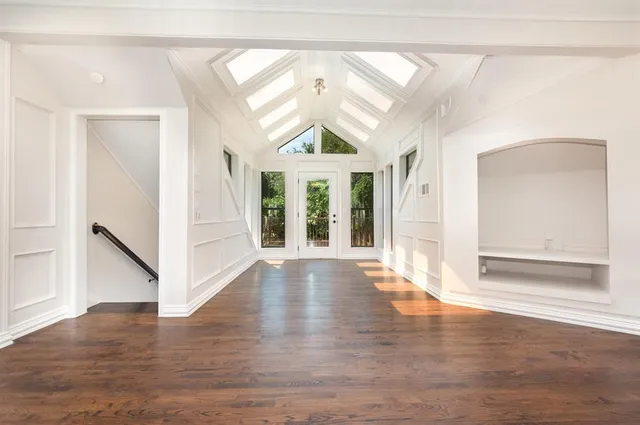 a view of an entryway with wooden floor and door