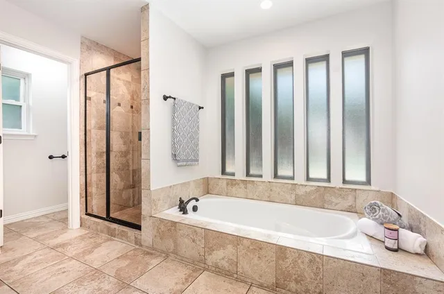 a bathroom with a bathtub and a shower