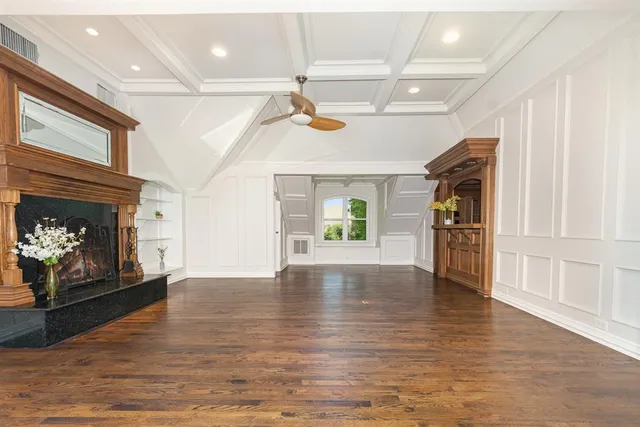 a view of an empty room and fire place