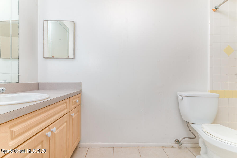 1330 Creel Road Northeast Palm Bay, FL 32905 - Photo 27 of 37 a bathroom with a granite countertop toilet and a sink