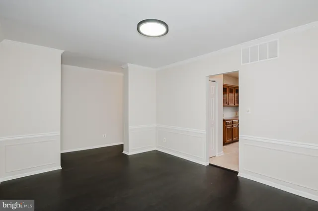 an empty room with wooden floor