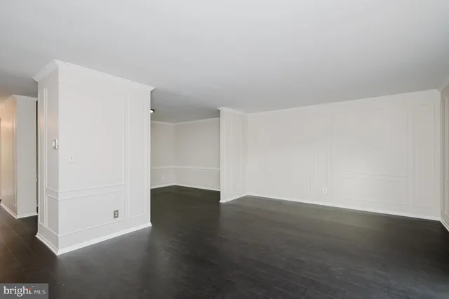 an empty room with wooden floor