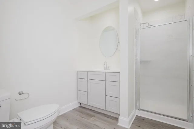 a bathroom with a toilet a sink and a mirror