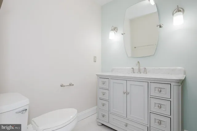 a bathroom with a sink a toilet and vanity