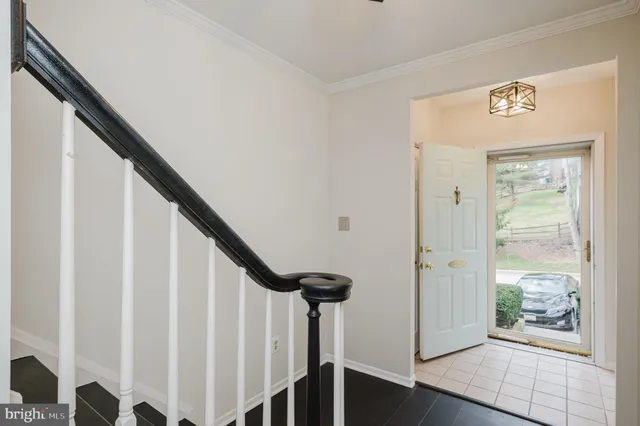 a view of entryway with wooden floor and stairs