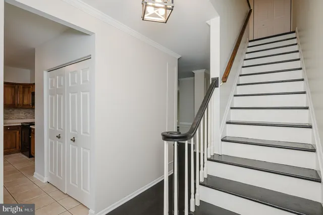 a view of entryway with wooden floor and stairs