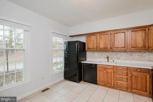 a kitchen with stainless steel appliances granite countertop a refrigerator and sink