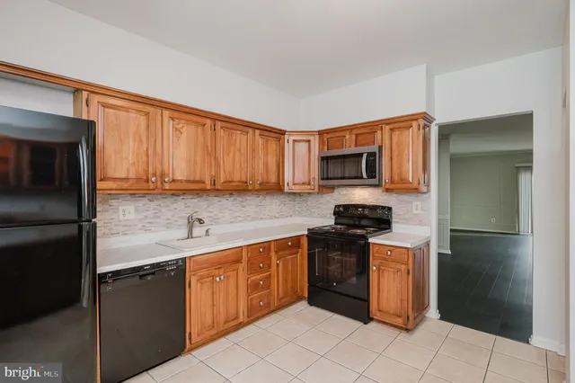 a kitchen with stainless steel appliances granite countertop a stove a refrigerator and a sink