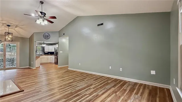 wooden floor in an empty room with a window