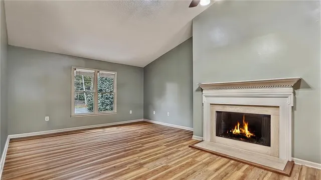 a view of a fireplace in an empty room with a fireplace