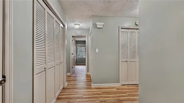 a view of a hallway with wooden floor