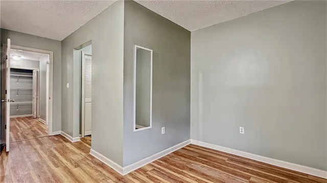 a view of a room with wooden floor and bathroom