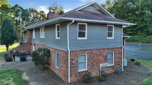 a front view of a house with a garden