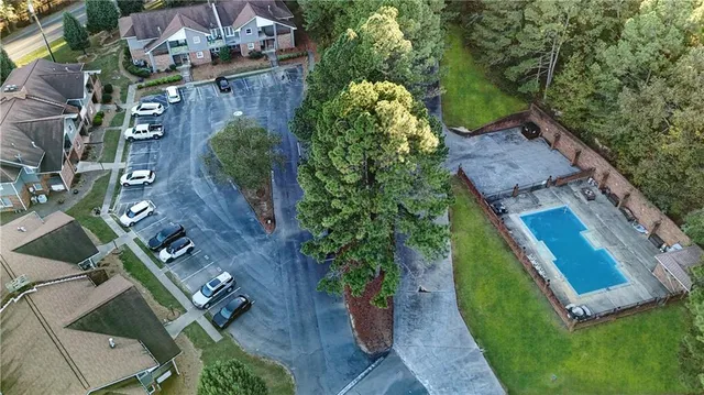 an aerial view of a house with a garden and trees