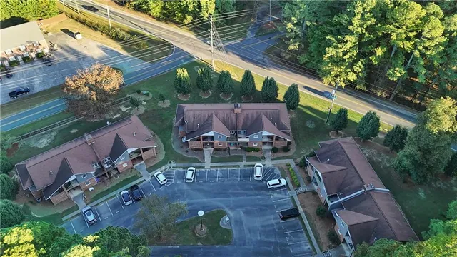a view of a patio with table and chairs potted plants and large tree