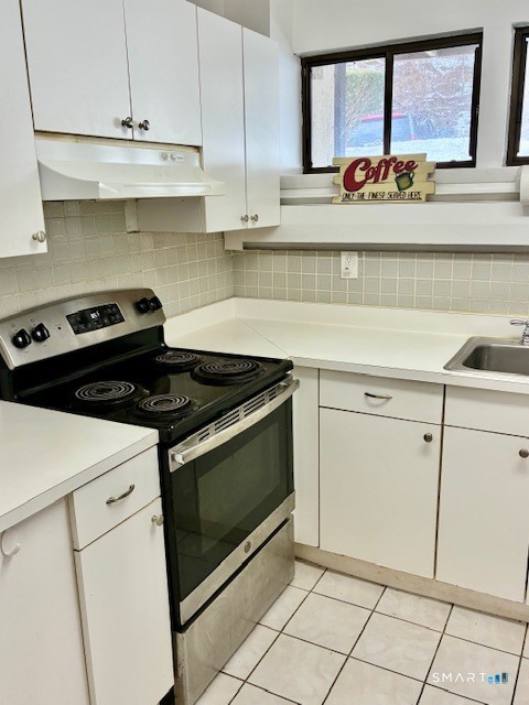 175 Mill Pond Road, Unit 201 Hamden, CT 06514 - Photo 3 of 8 a kitchen with cabinets and appliances