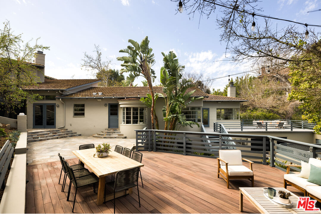 2510 Park Oak Drive Los Angeles, CA 90068 - Photo 13 of 38 a view of a patio with table and chairs with wooden floor and fence