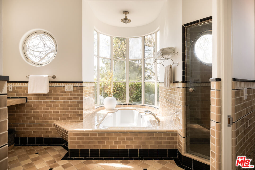 2510 Park Oak Drive Los Angeles, CA 90068 - Photo 18 of 38 a bathroom with a sink a mirror and a shower