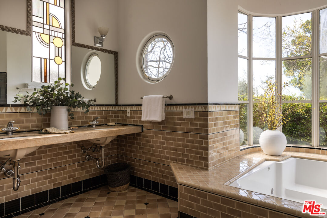 2510 Park Oak Drive Los Angeles, CA 90068 - Photo 19 of 38 a bathroom with a sink mirror vanity and a window