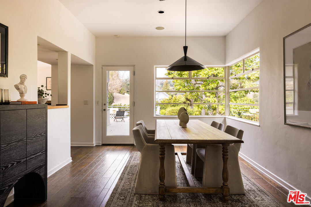 2510 Park Oak Drive Los Angeles, CA 90068 - Photo 6 of 38 a dining room with a table chairs and a kitchen view