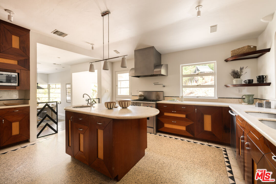 2510 Park Oak Drive Los Angeles, CA 90068 - Photo 8 of 38 a kitchen with a sink stove and cabinets