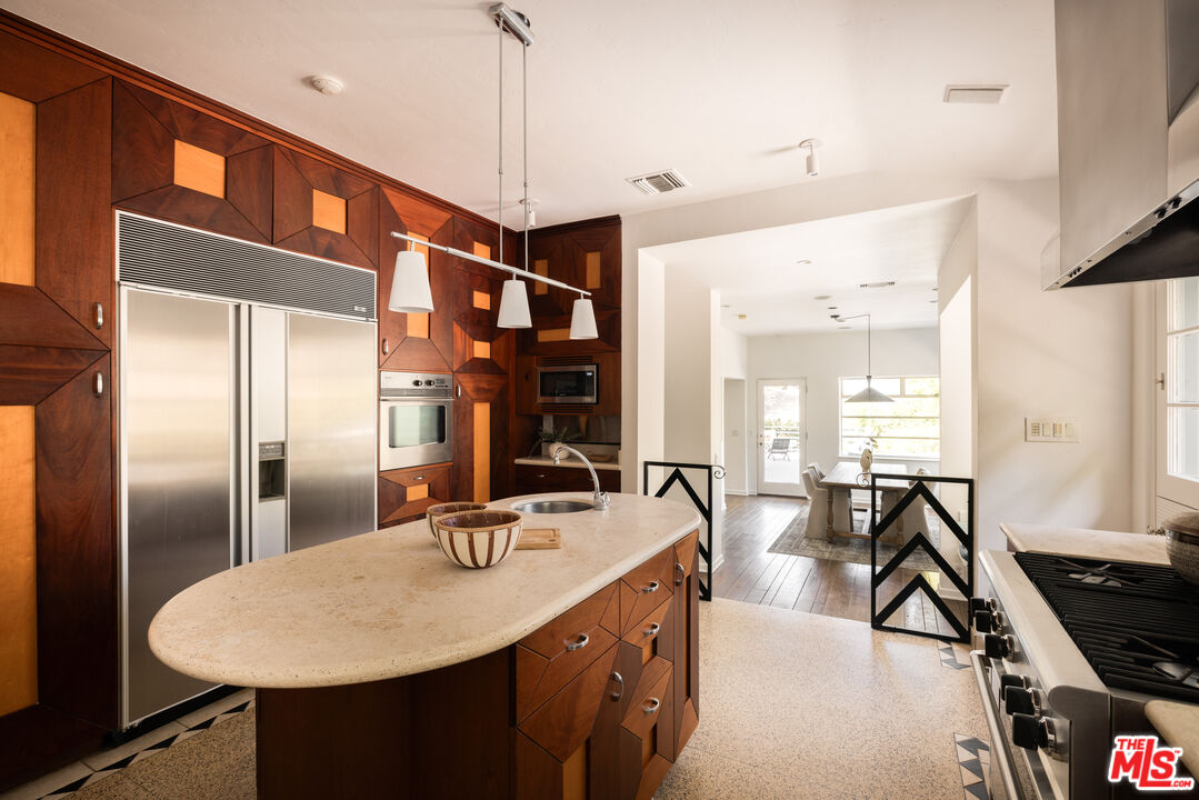2510 Park Oak Drive Los Angeles, CA 90068 - Photo 9 of 38 a kitchen with stainless steel appliances granite countertop a sink a stove and a refrigerator