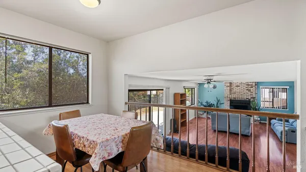 a dining room with furniture and wooden floor