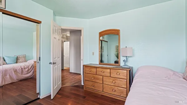 a bedroom with a bed and a dresser in it