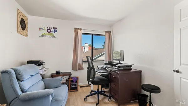 a view of workspace with wooden floor windows