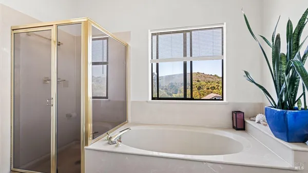 a white bath tub sitting next to a window