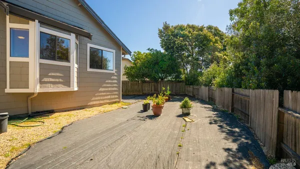 a view of the house with backyard and sitting area