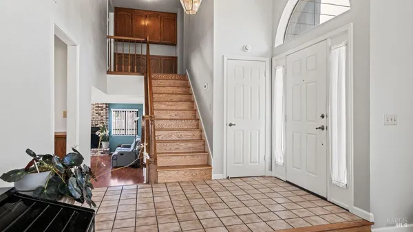 a view of a hallway with wooden floor and entryway