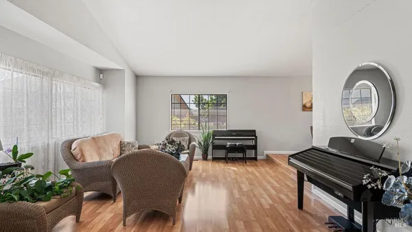 a living room with furniture and a piano