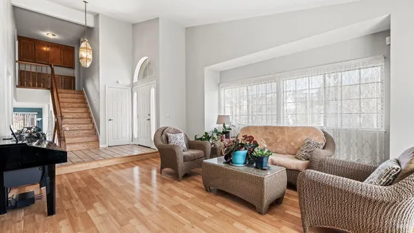 a living room with furniture and wooden floor