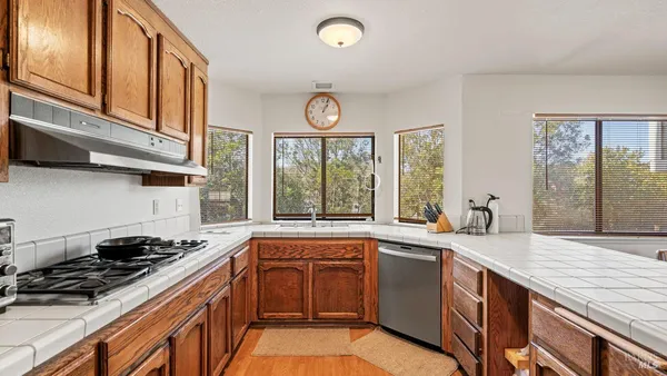 a kitchen with a sink stove and cabinets