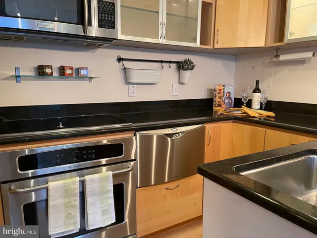 a kitchen with granite countertop a stove and cabinets