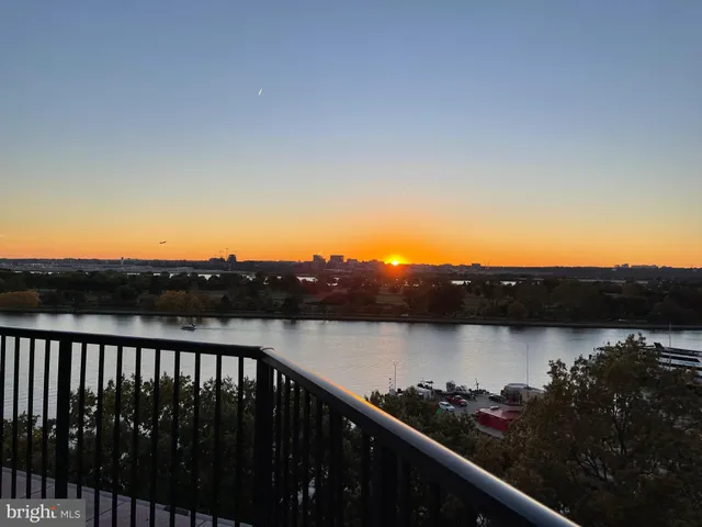 a view of a large building with a bench in front of building