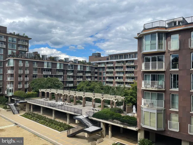 a view of swimming pool with outdoor seating and lake view