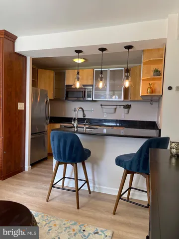 a kitchen with a table and chairs in it