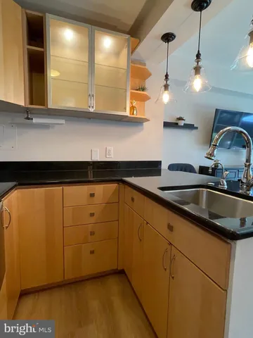 a kitchen with stainless steel appliances granite countertop a sink a stove and cabinets