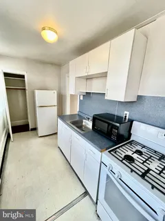 a kitchen with a stove and a refrigerator