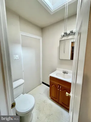 a bathroom with a toilet a sink and mirror