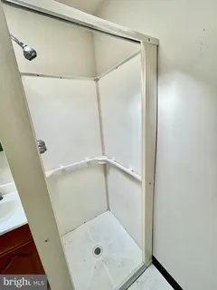 a bathroom with a glass shower door