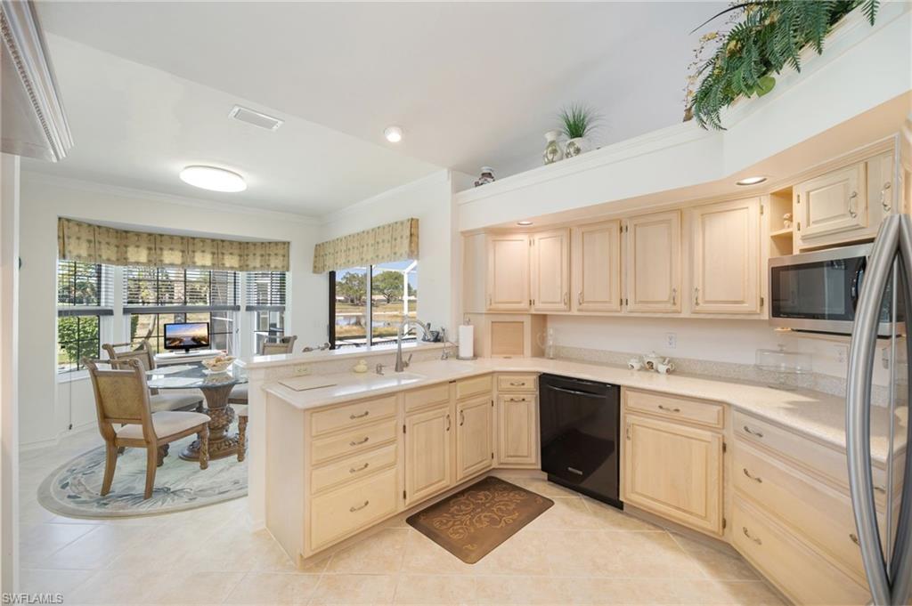 867 St Andrews Boulevard Naples, FL 34113 - Photo 11 of 28 a kitchen with a sink stove and cabinets