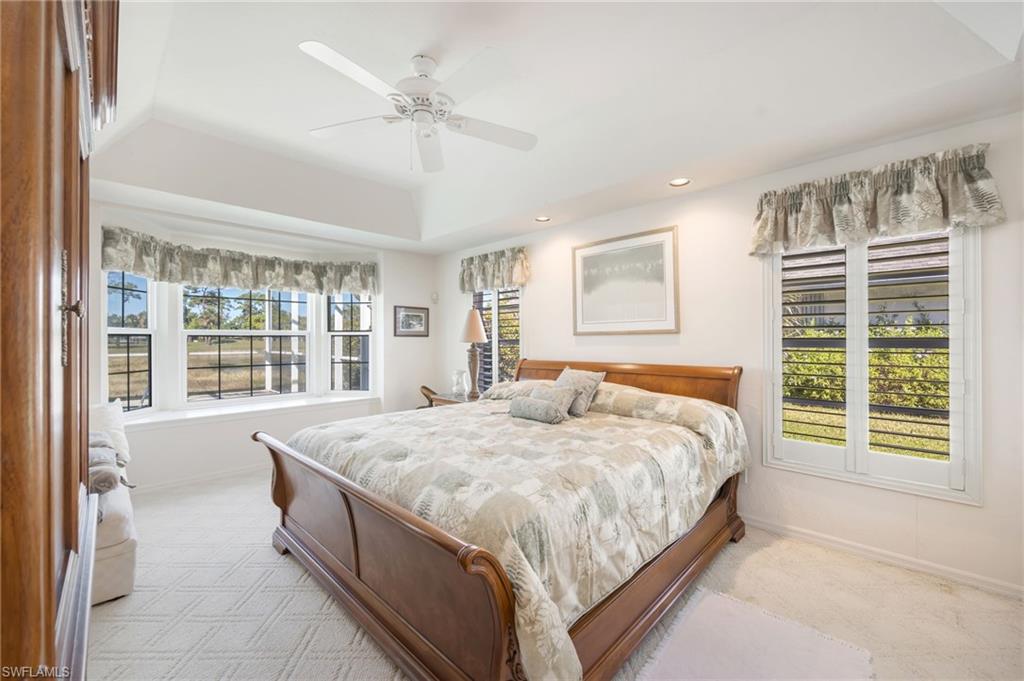 867 St Andrews Boulevard Naples, FL 34113 - Photo 14 of 28 a bedroom with a large bed and a large window