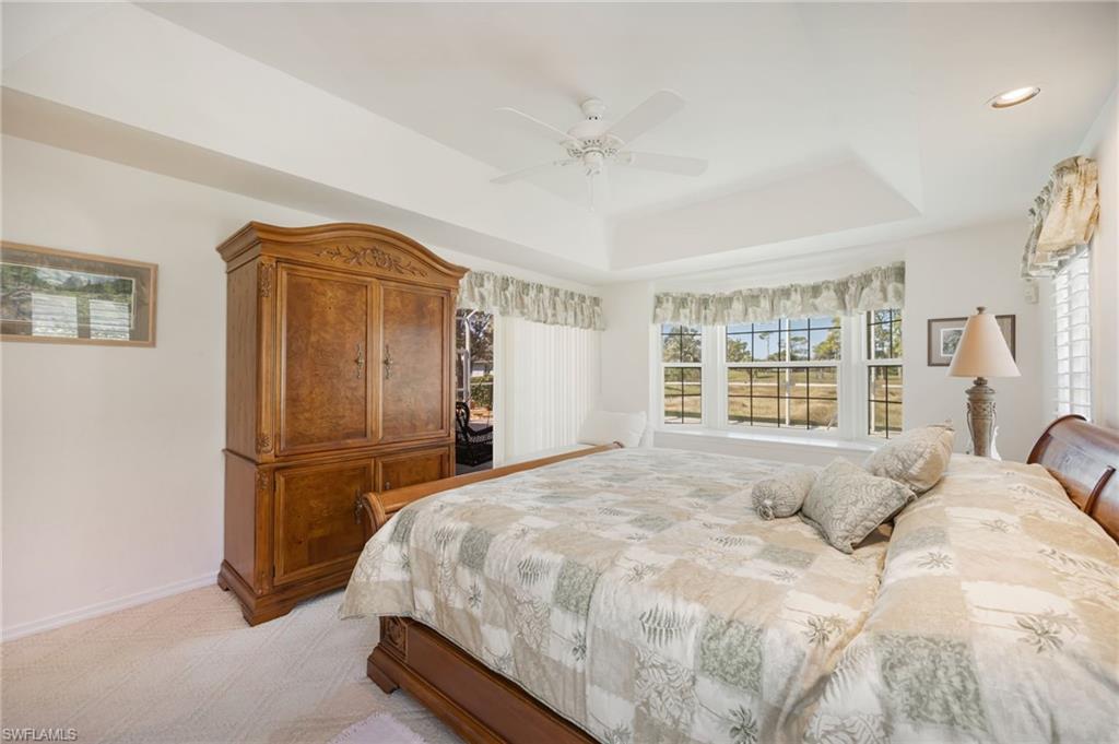 867 St Andrews Boulevard Naples, FL 34113 - Photo 15 of 28 a bedroom with a bed and a large window