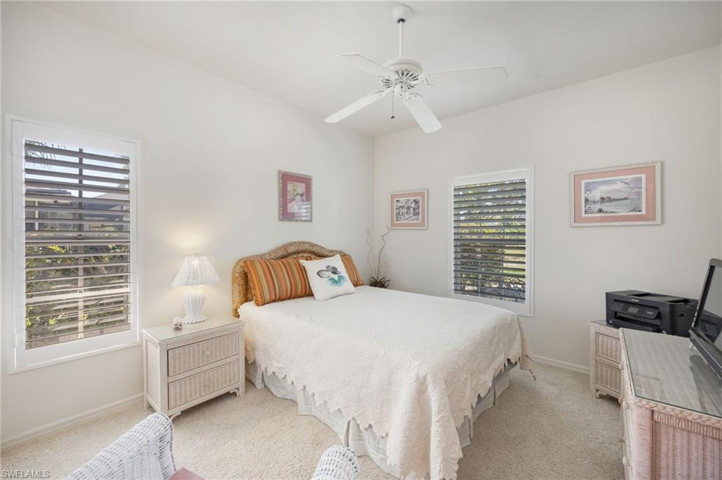 867 St Andrews Boulevard Naples, FL 34113 - Photo 20 of 28 a bedroom with a bed and a window