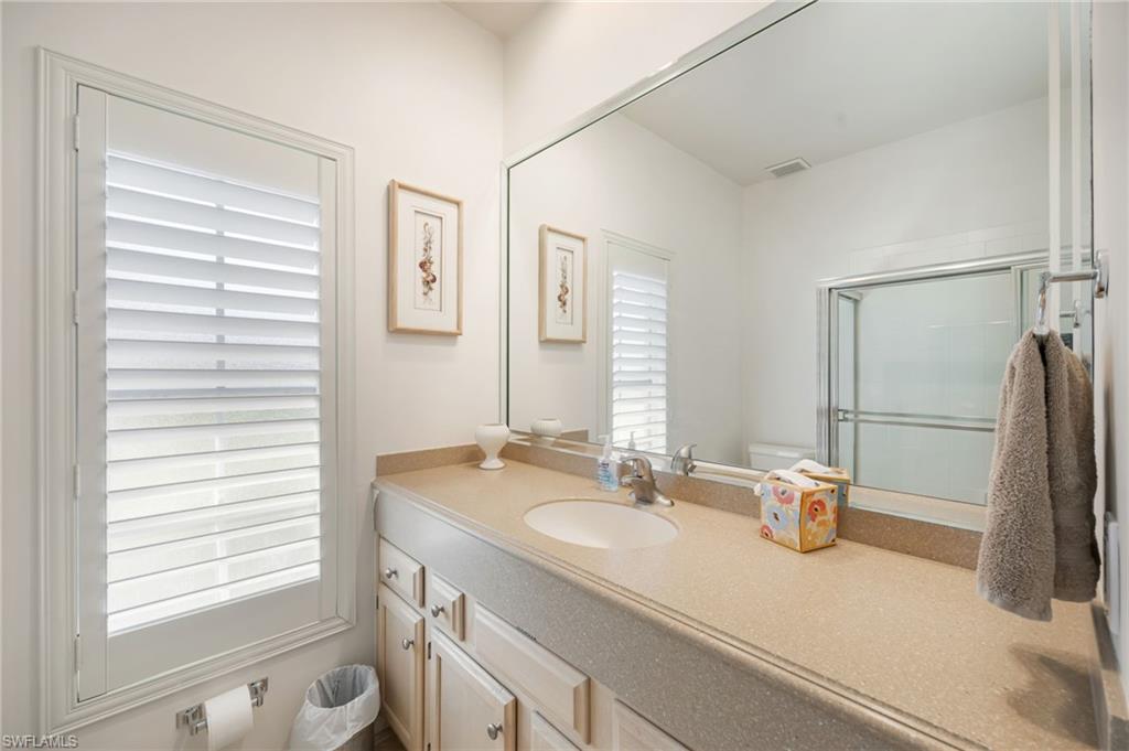 867 St Andrews Boulevard Naples, FL 34113 - Photo 21 of 28 a bathroom with a sink and a mirror